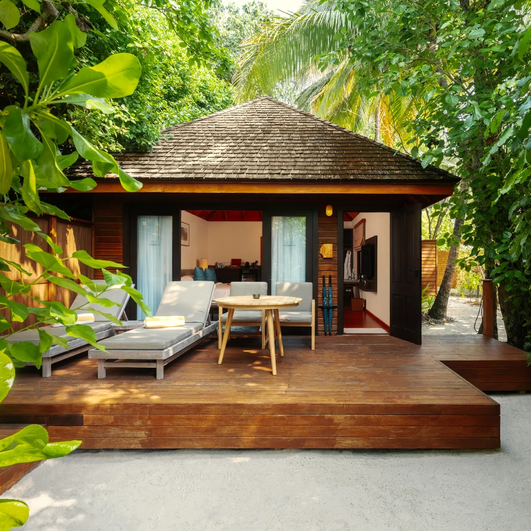The timber veranda of a Beach Villa, among the greenery.