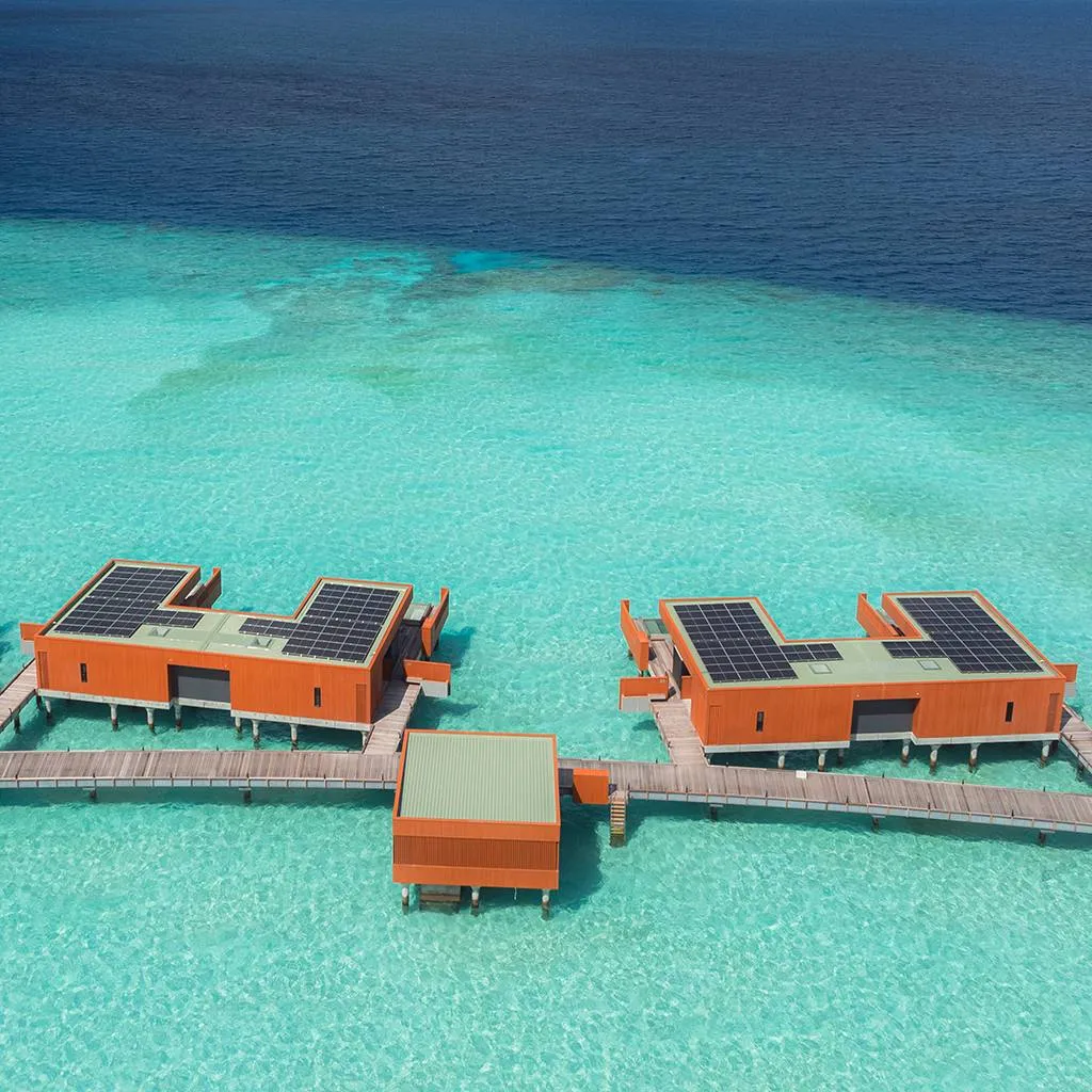 2 overwater pool villas from above, over the lagoon.