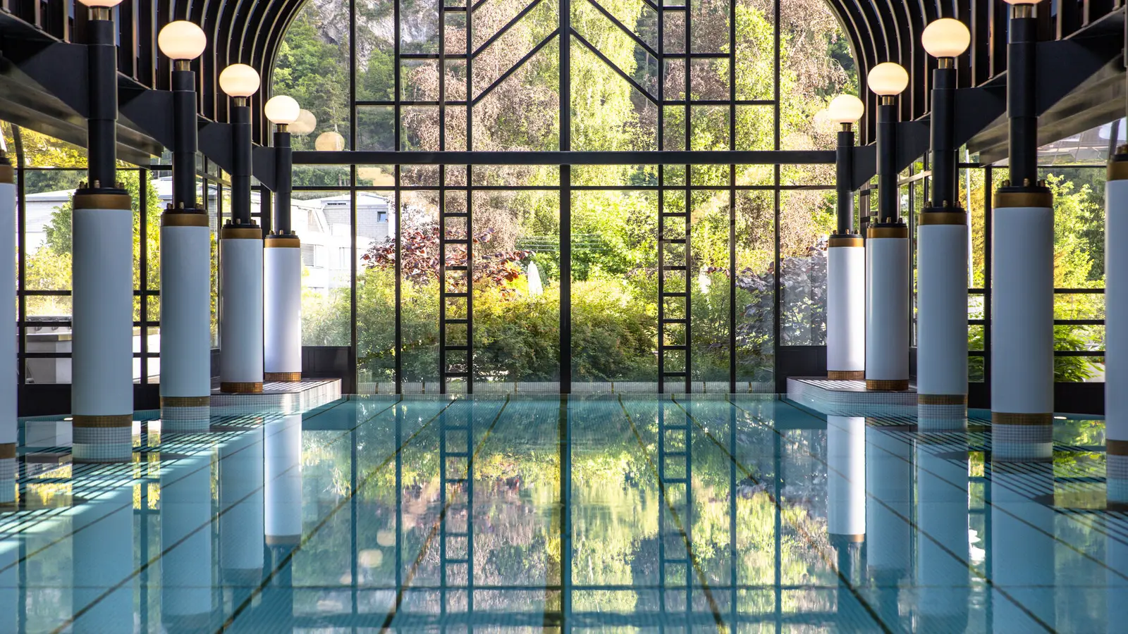 The indoor pool at Victoria-Jungfrau beneath its glass roof