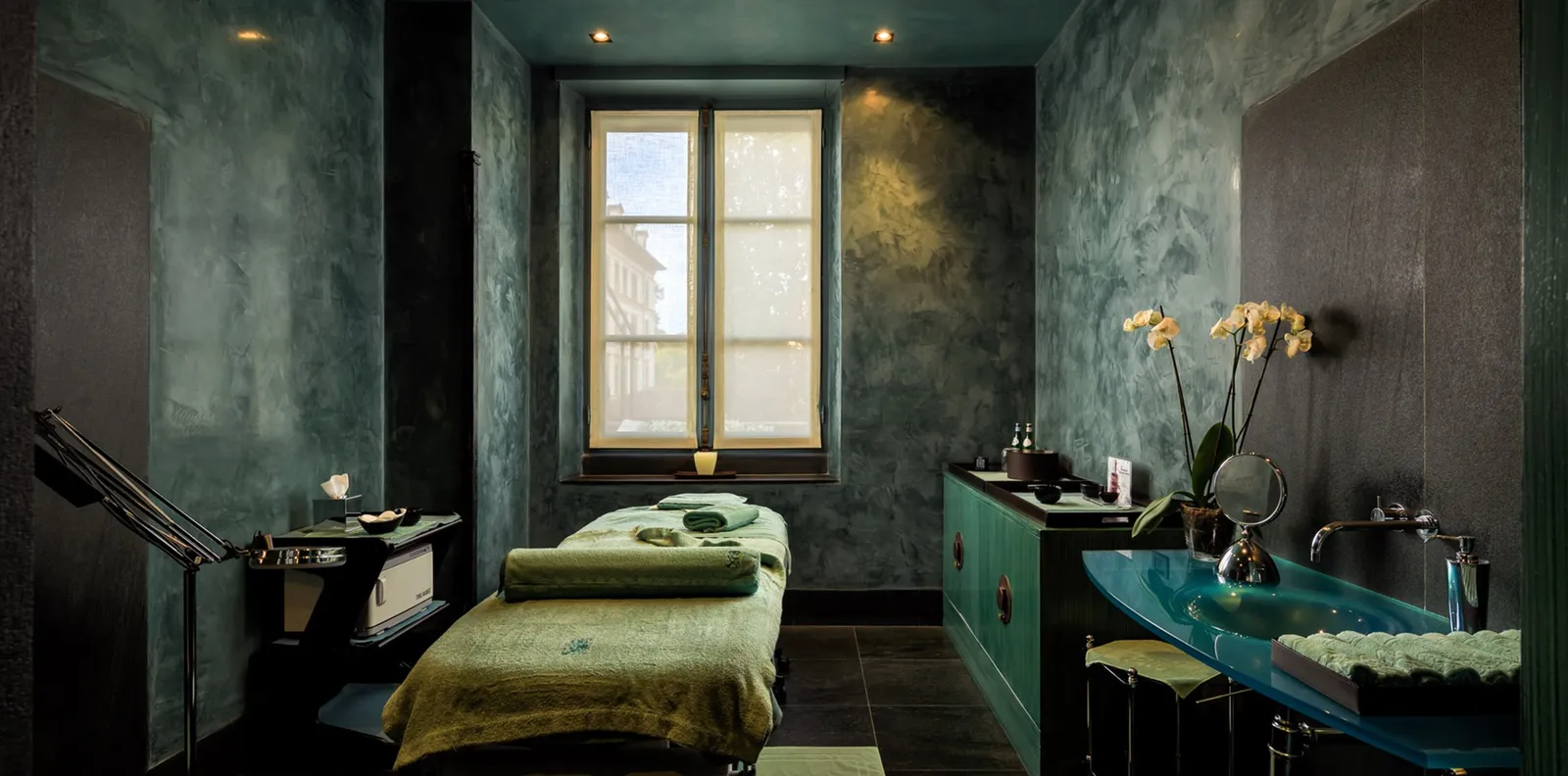 A treatment room in the Beauty Center with green walls