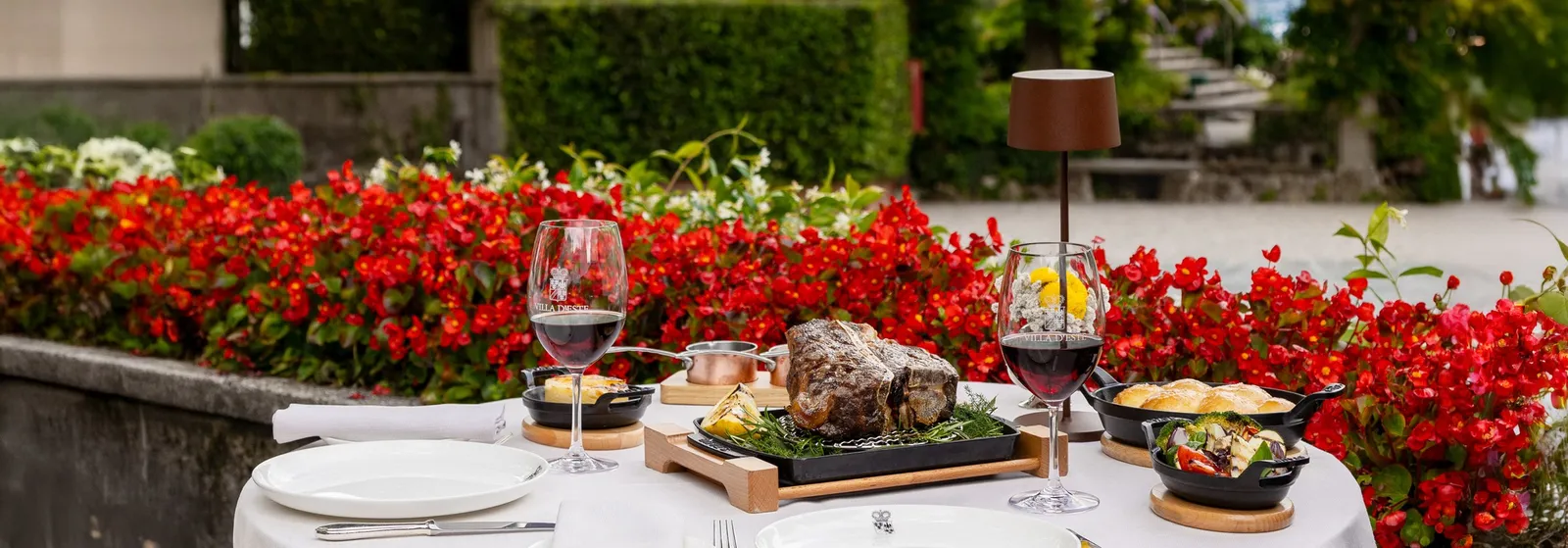 A table at the Grill with red flowers
