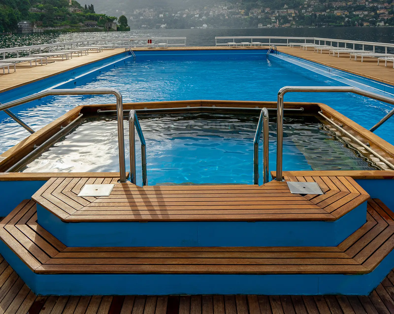 The outdoor Jacuzzi over the lake with a teak surround