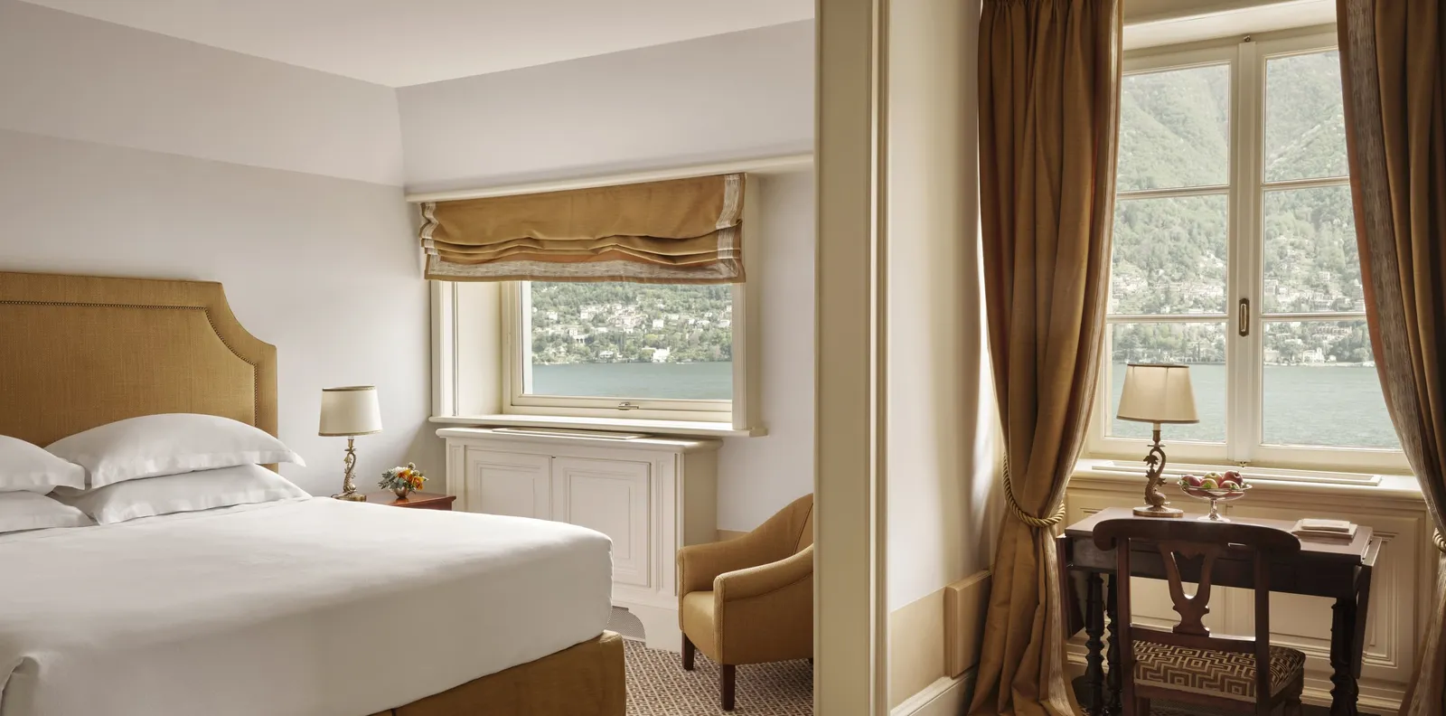 A Deluxe Room with the bed and the lake at the window