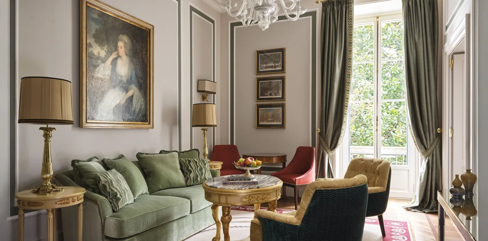 The Executive Suite’s living room with a green sofa and a portrait