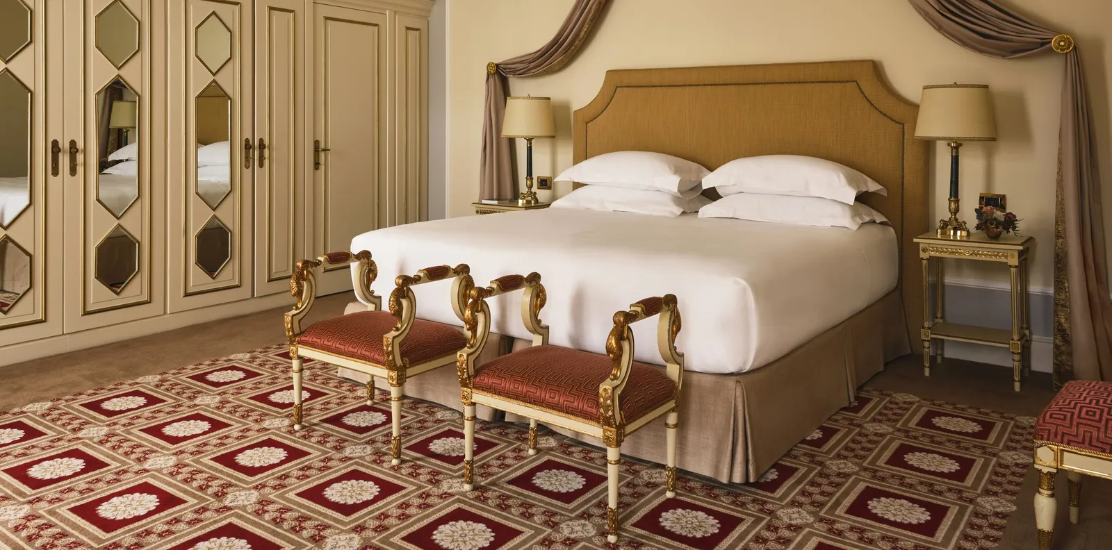 The Presidential Suite’s bedroom with a red patterned carpet