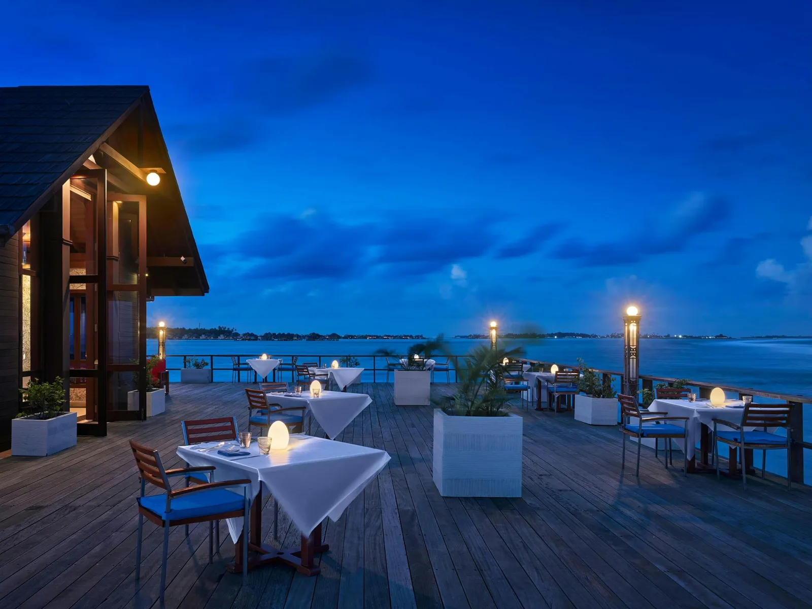 Hook’s deck at the end of the jetty, laid for the evening with candles on the tables and the sea beyond.