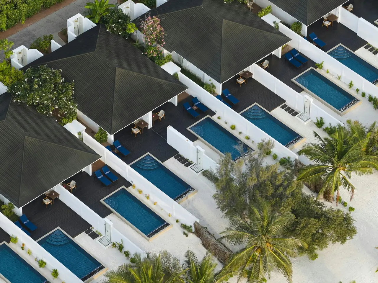 The Two-bedroom Beach Villas with Two Pools from above, each villa’s 2 pools between white walls.