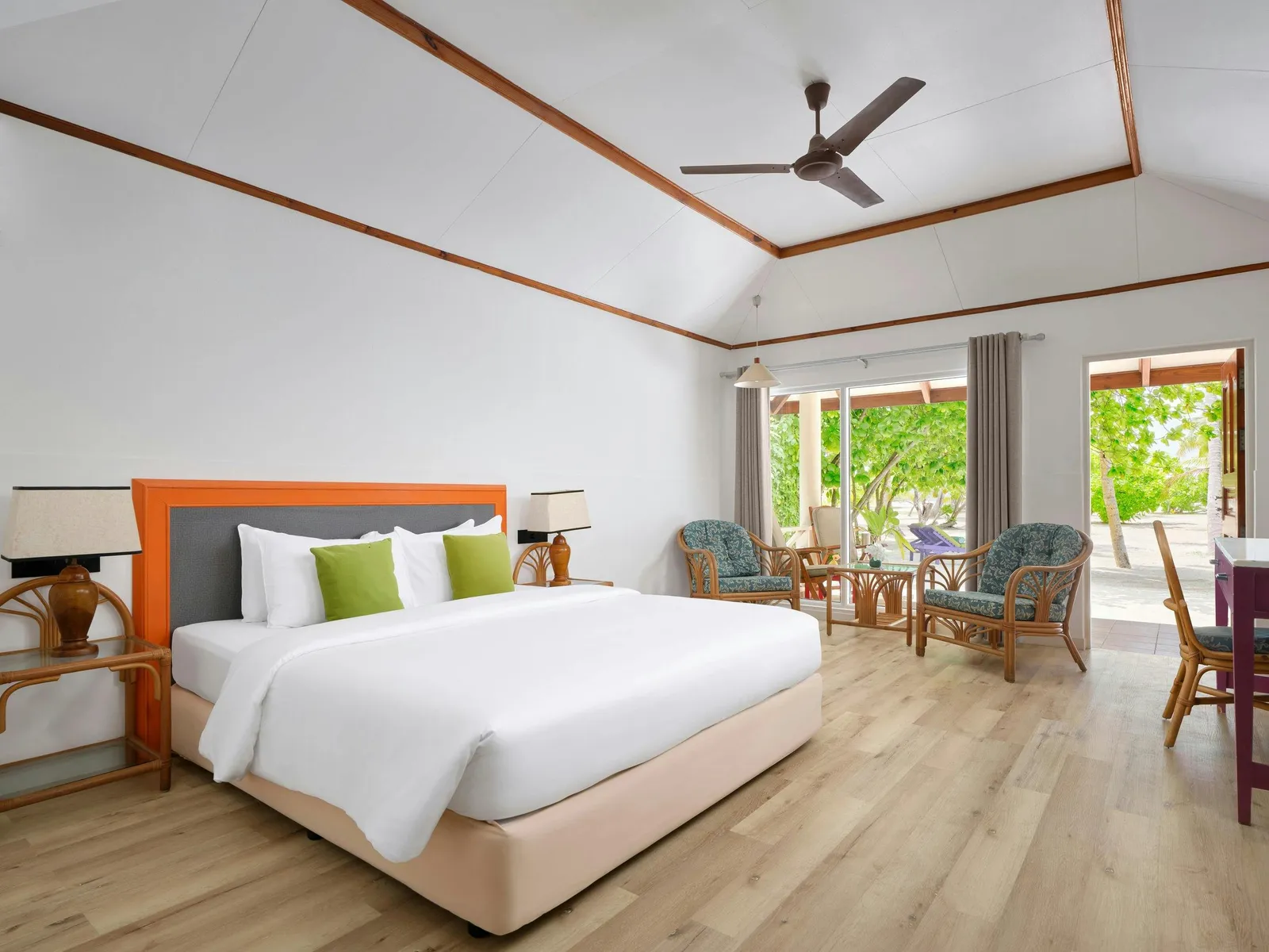 Bedroom with bed and terrace among trees.