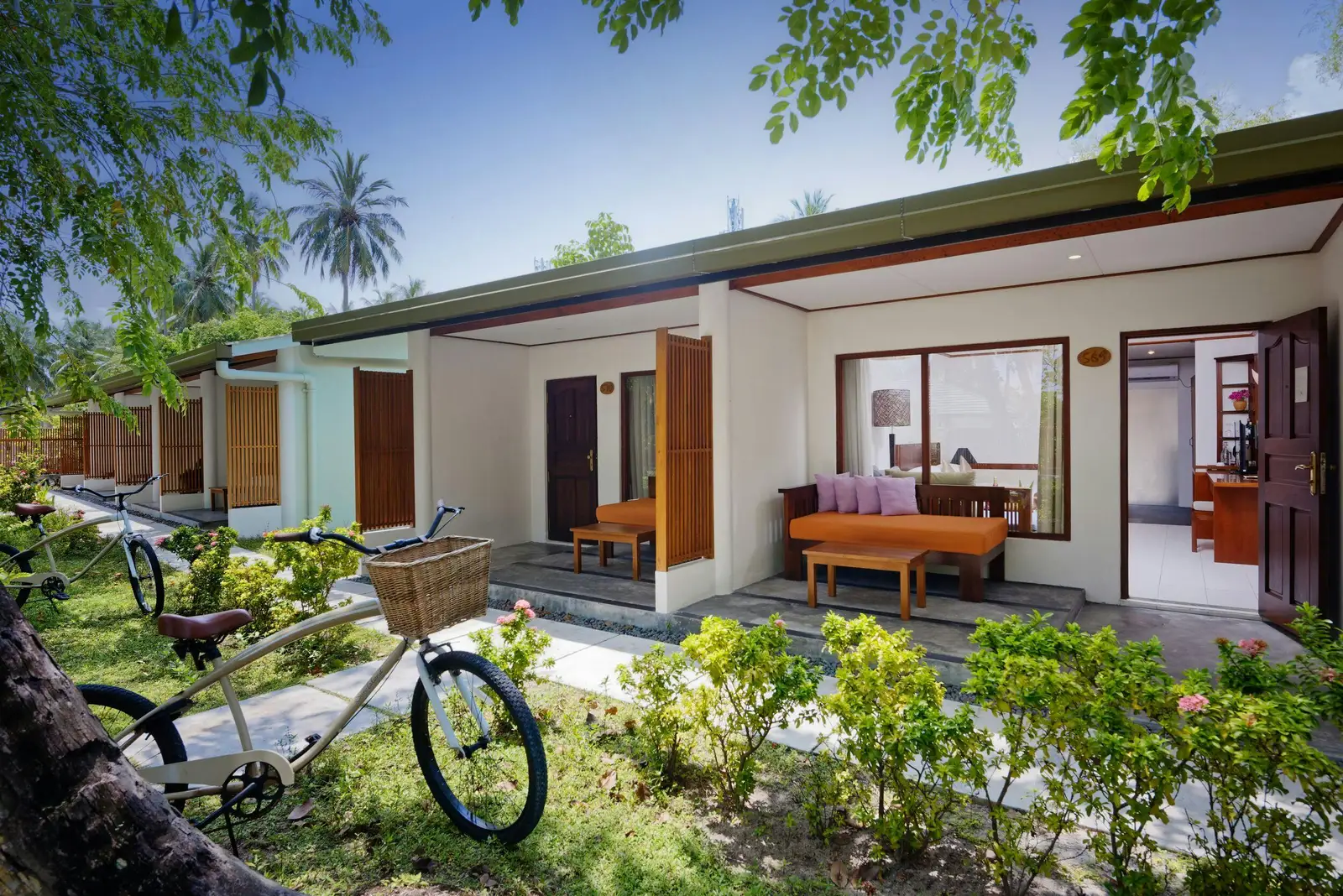 Garden villa with veranda and bicycles.