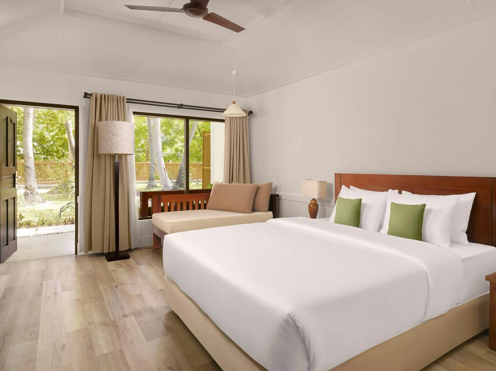 Sun Villa — Bedroom with bed, sofa/daybed, desk and garden-facing doors.