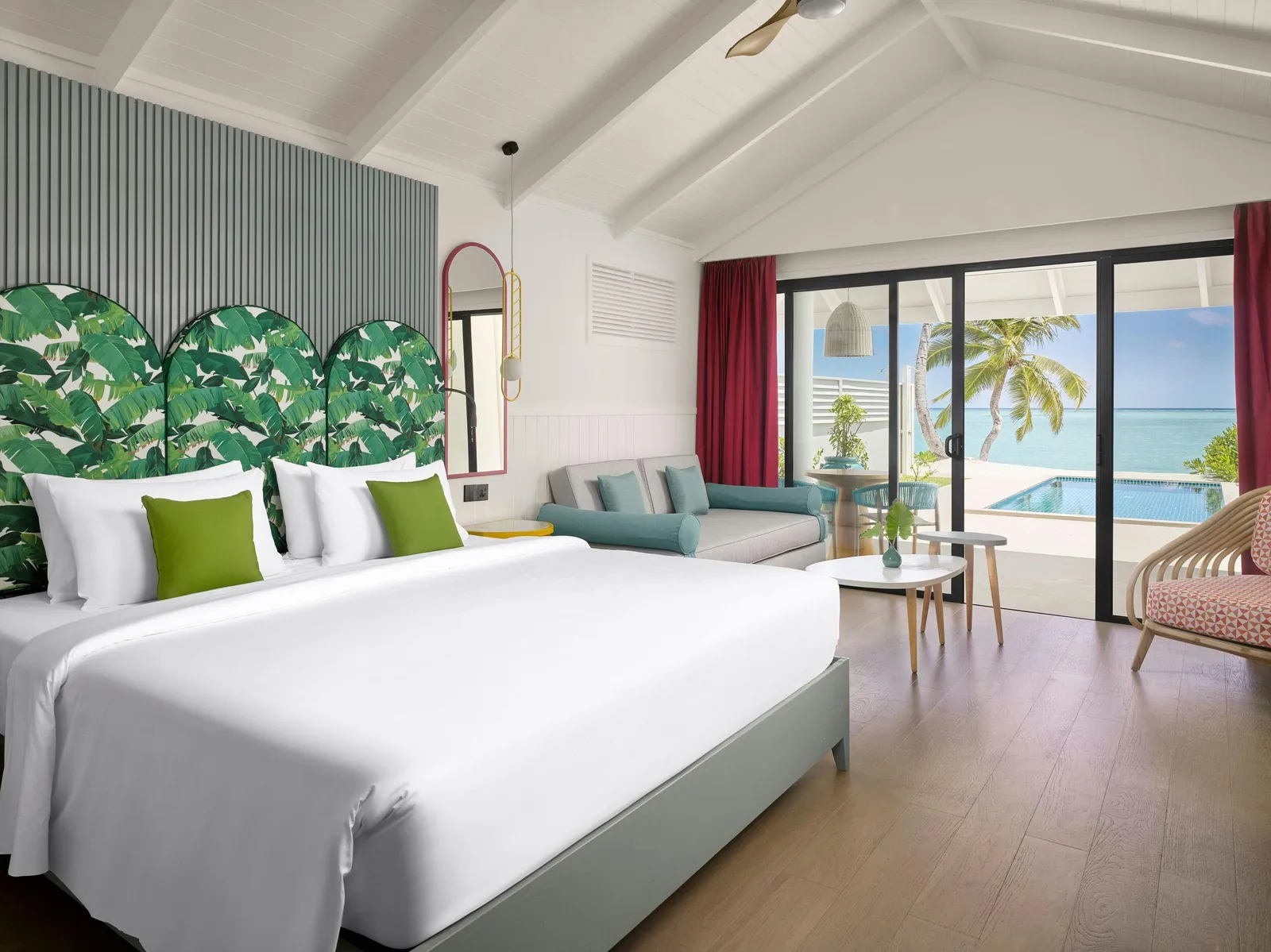 Bedroom with bed and doors towards the beach.