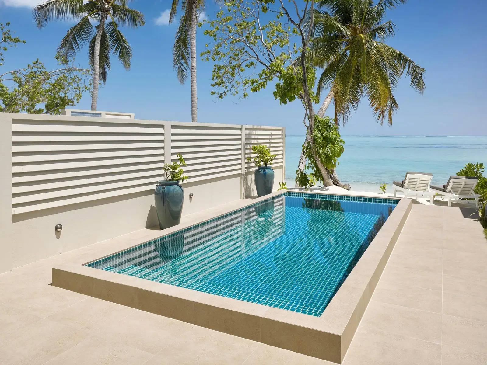 2 Bedroom Beach Pool Villa — Beachside private pool bordered by terrace, palms and sea.