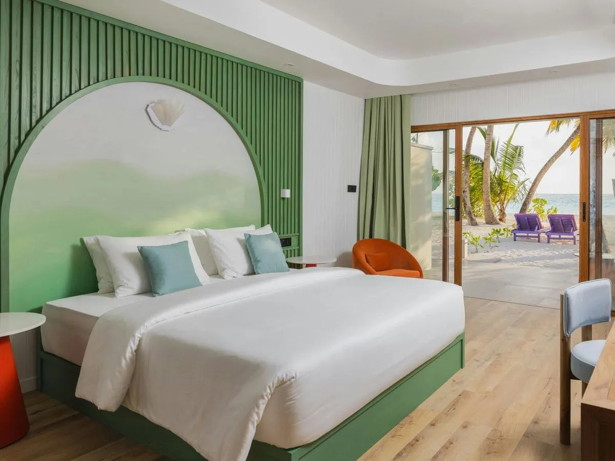 Bedroom with bed and door towards the terrace.