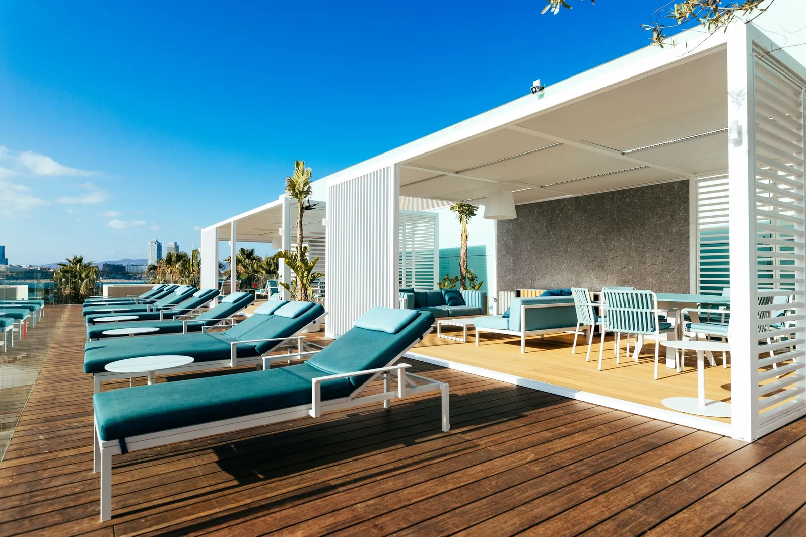 The white cabanas of the Altitude Terrace with teal loungers