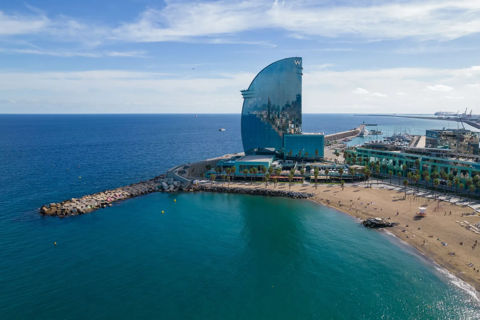 The tower from the sea, with Sant Sebastià beach and the breakwater