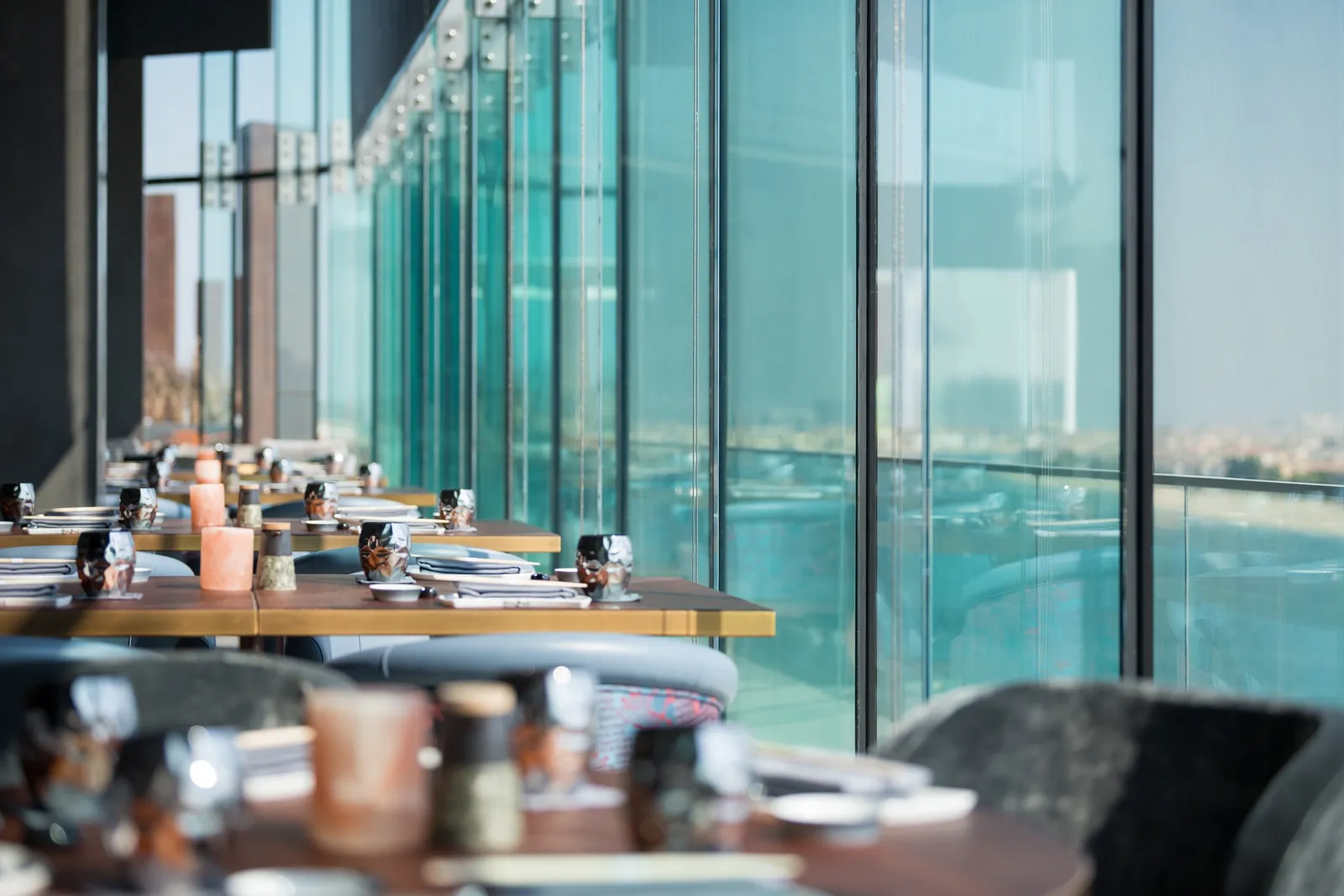 Akira Back’s dining room with tables along the glass over the Marina
