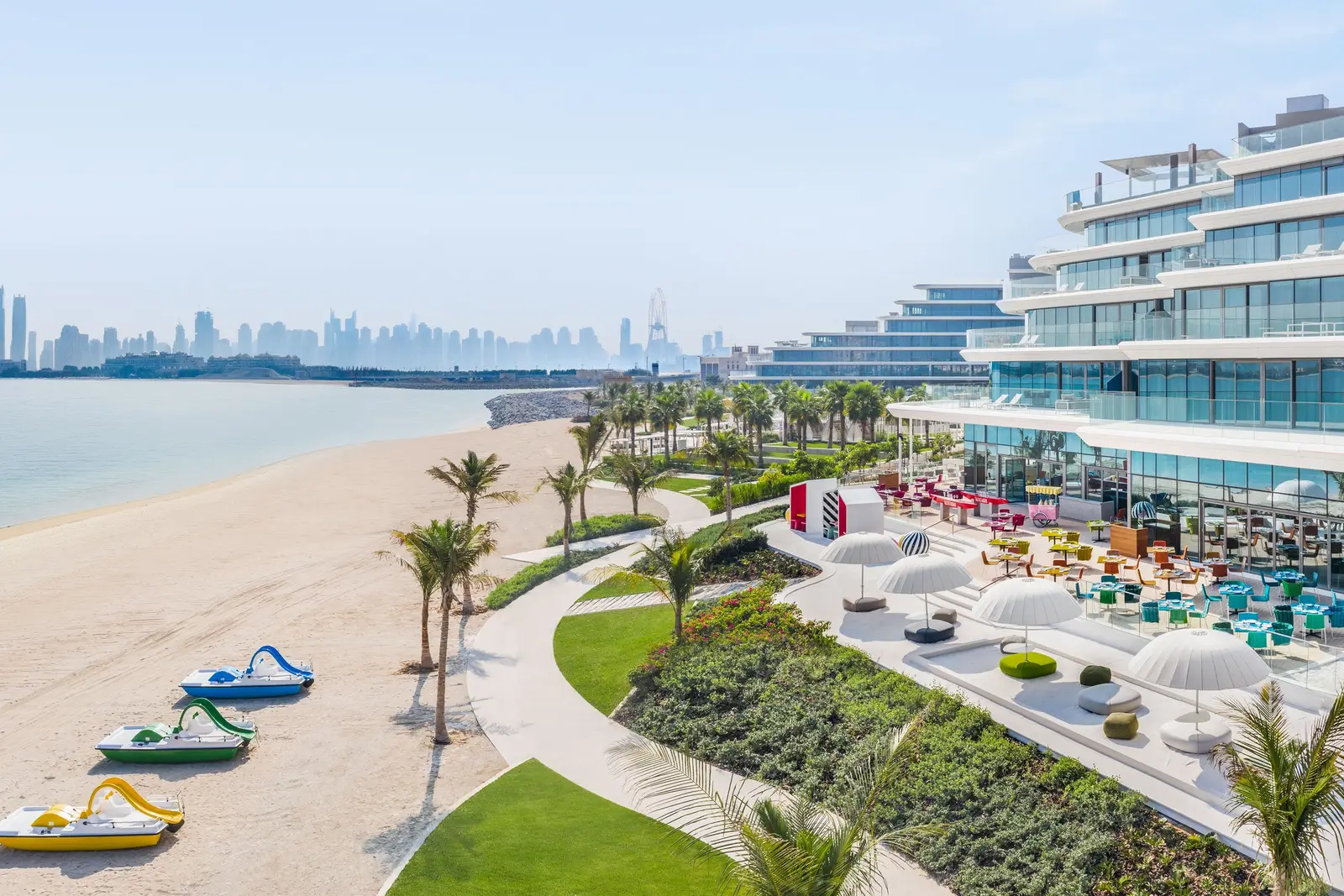 The beach below the hotel with pedal boats, palms and the Marina towers