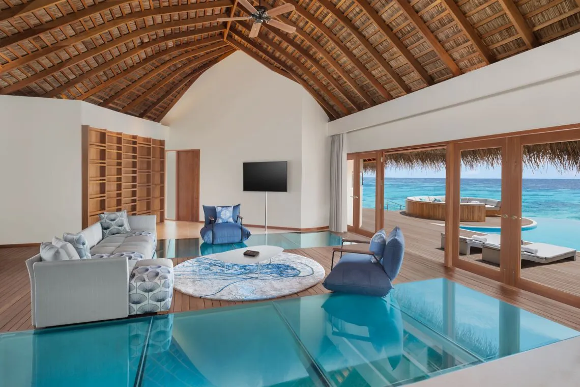 The Oasis Overwater living room with sofas and an ocean-facing deck