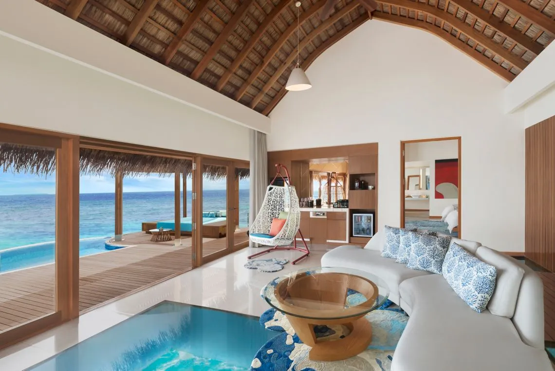 The Supreme Overwater living room with a glass floor panel