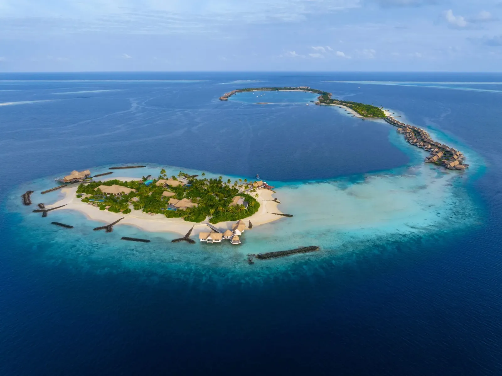 Ithaafushi Private Island from the air, with its crescent of reef