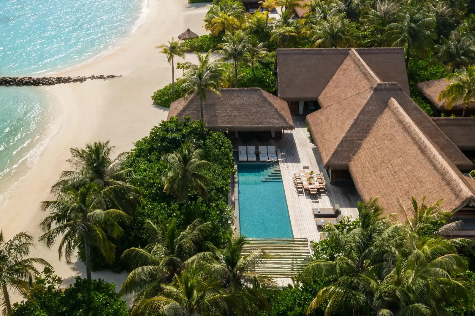 A 2-bedroom beach villa from the air, its pool among the palms