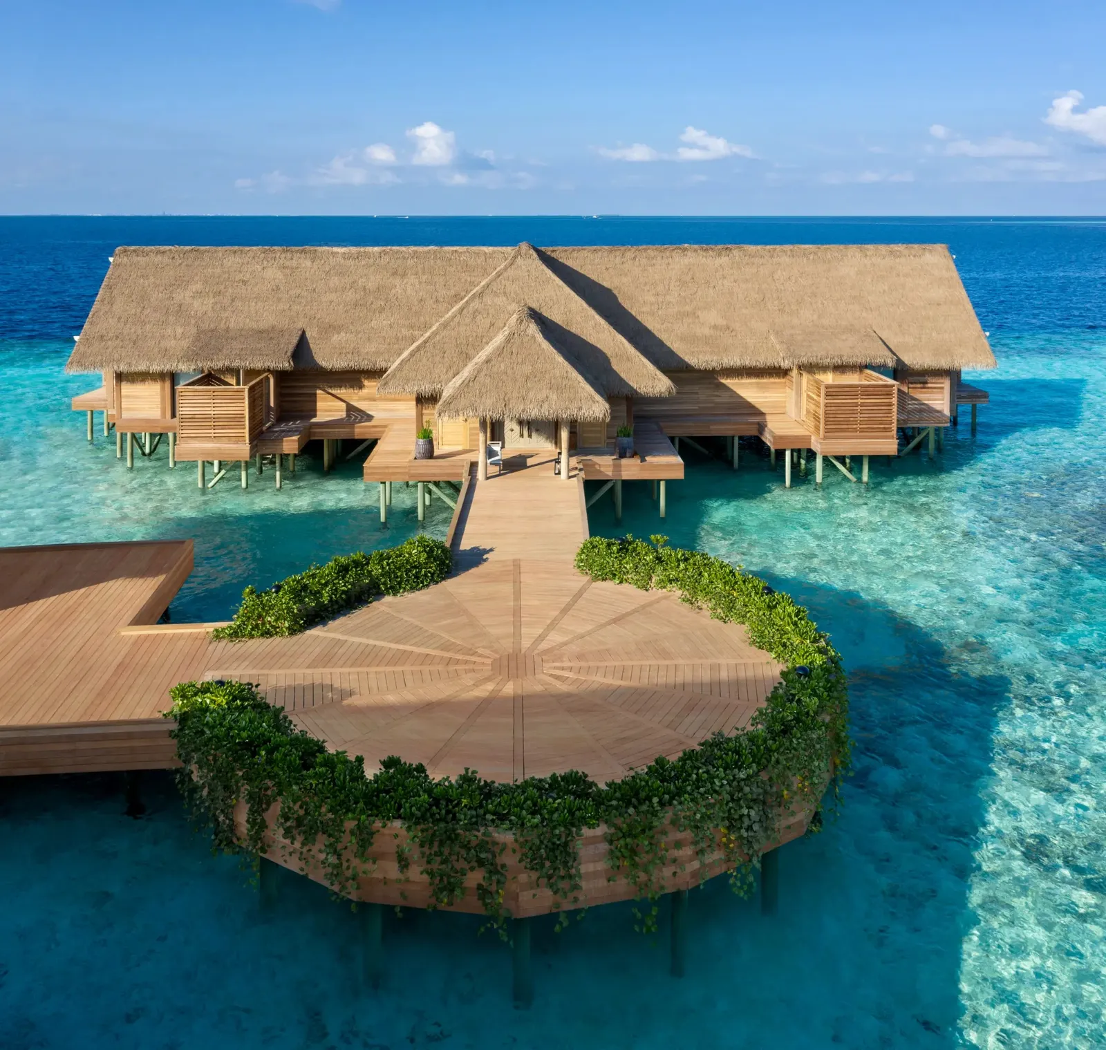 The Two Bedroom Overwater Villa from the air, on its own green islet