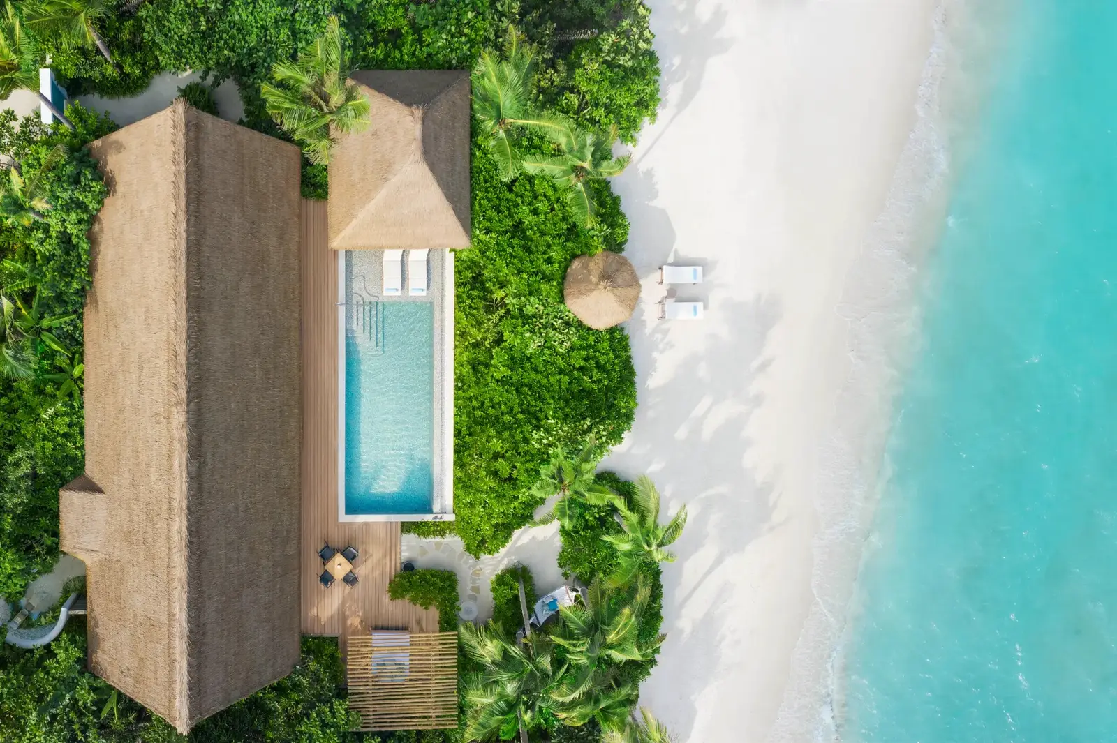 King Beach Villa from above: the long pool between the greenery and the beach
