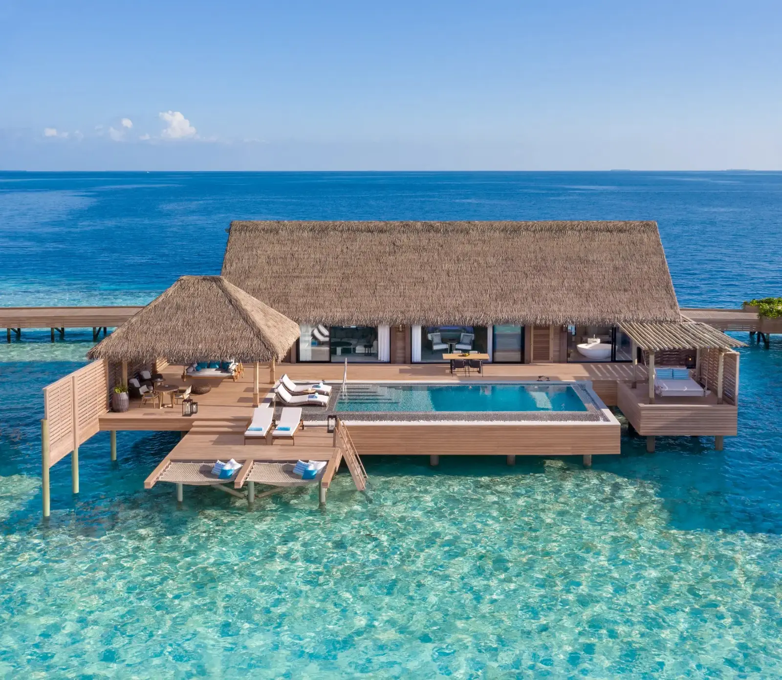 King Grand Overwater Villa from the air, alone on turquoise water