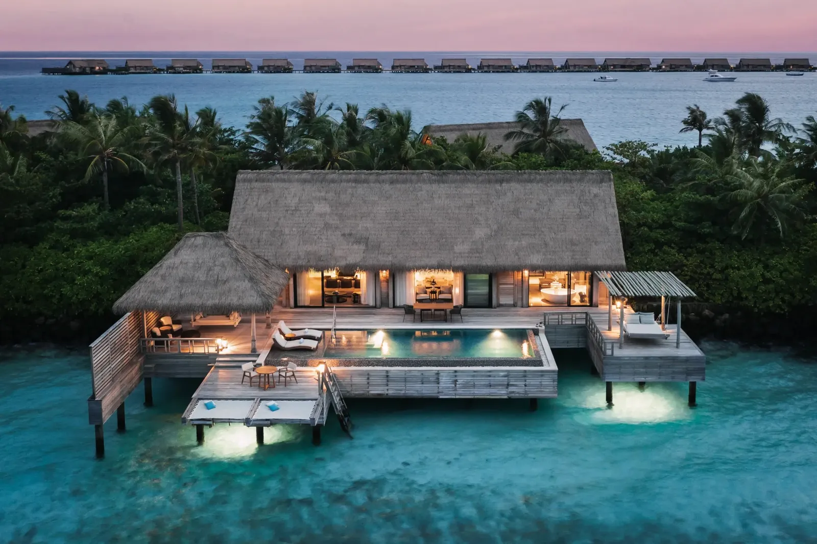 King Grand Reef Villa in the evening, over the reef, lights on
