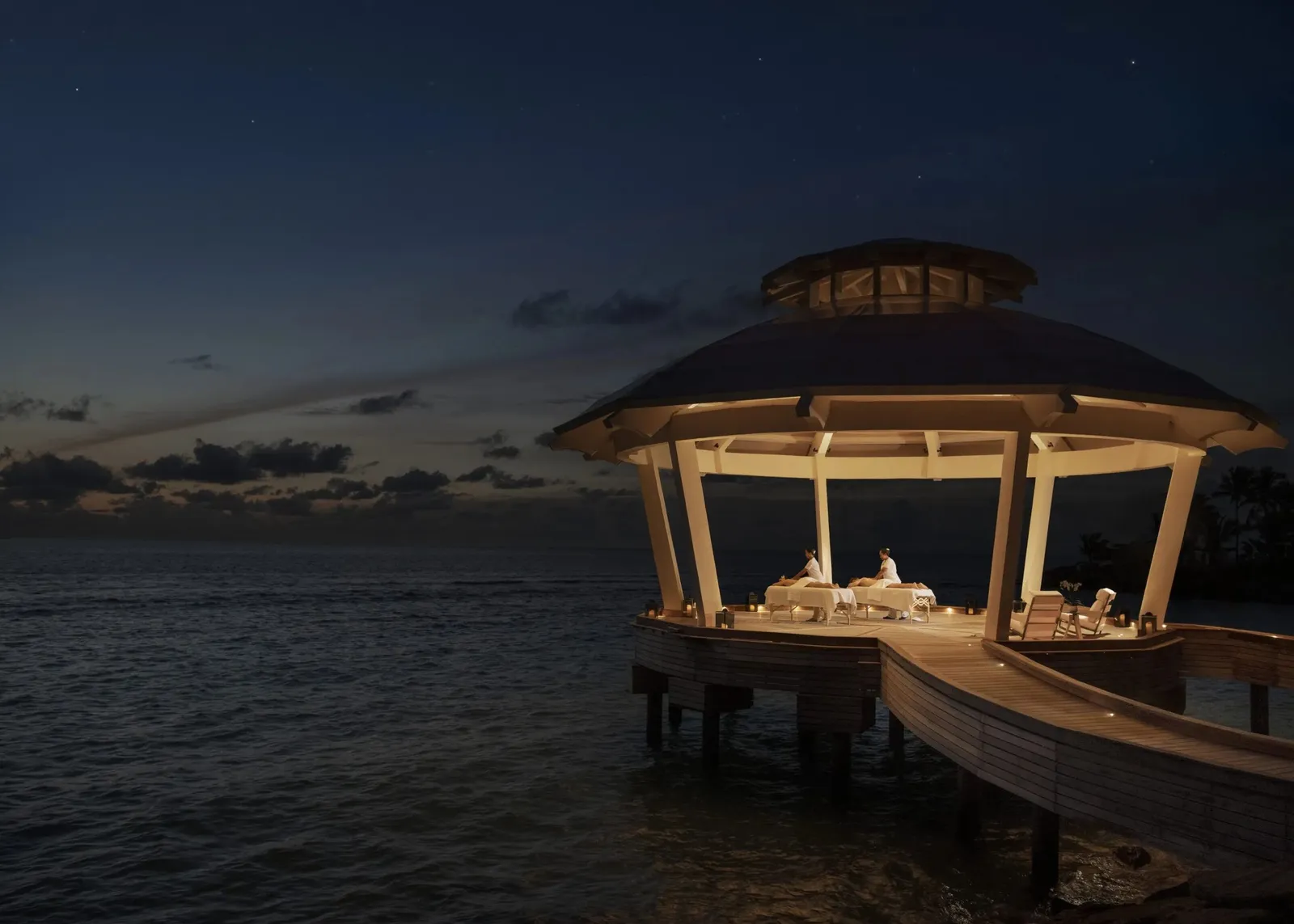 The spa pavilion over the water at night, lit up