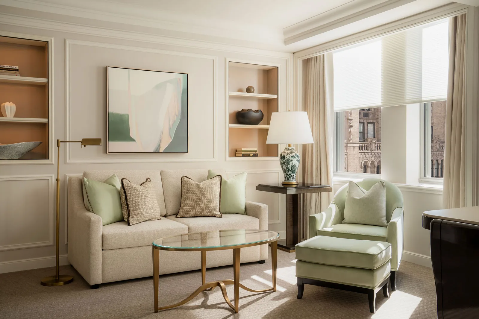 The sofa and green armchair of the Lexington Avenue Junior Suite