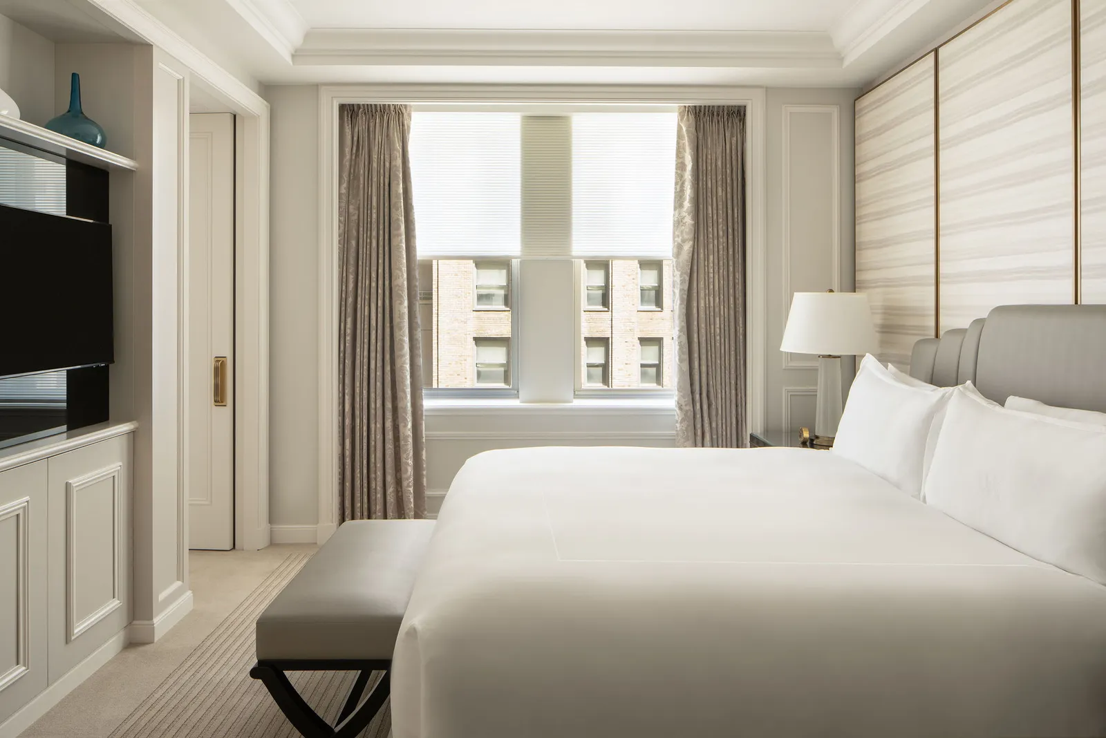 The Lexington Avenue One Bedroom Suite bedroom with a bench at the foot of the bed