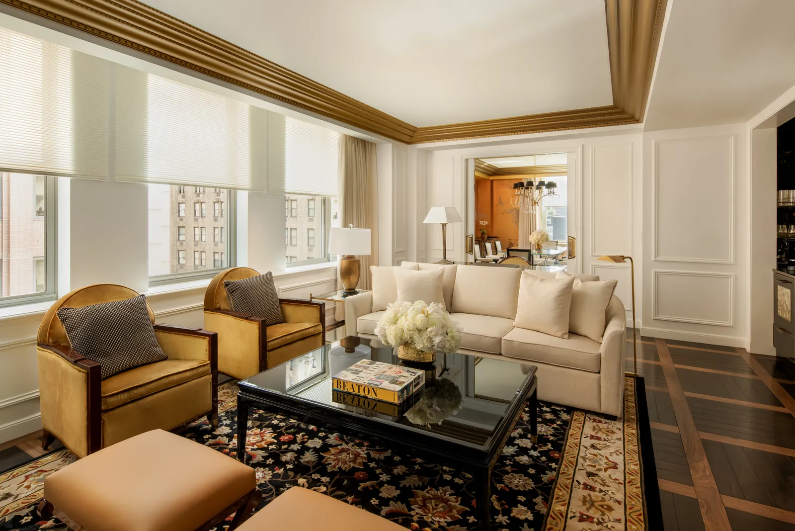 The Manhattan Suite living room, its gilded armchairs and dark rug