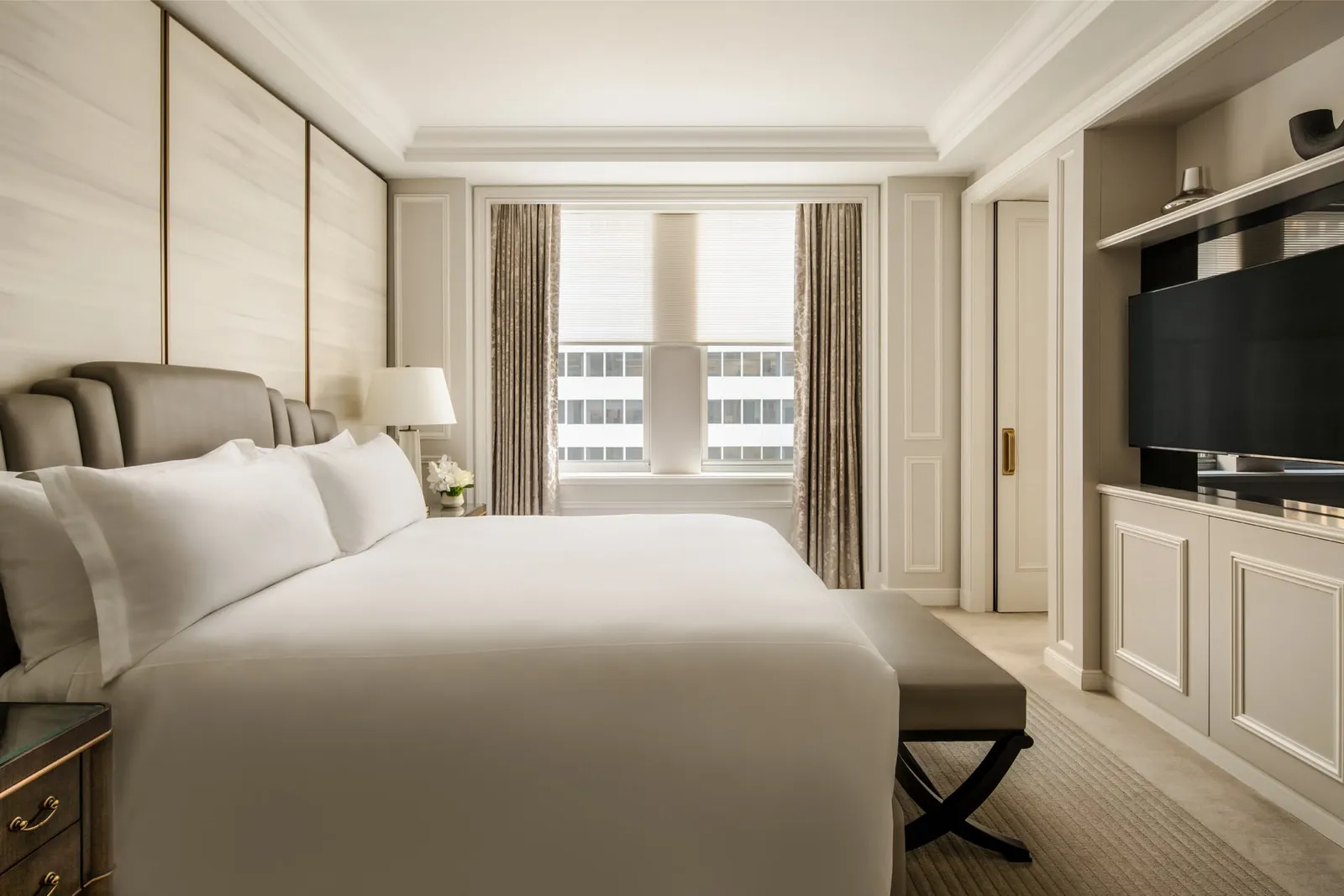 The Park Avenue One Bedroom Suite’s king bed before the windows