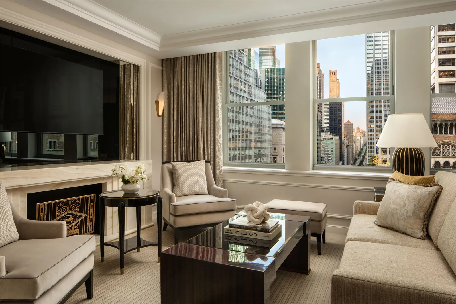 The Park Avenue Premier Suite living room with its fireplace and the towers outside