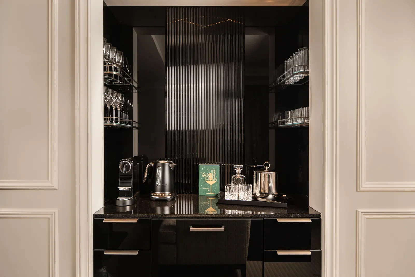 A suite’s black lacquered bar cabinet