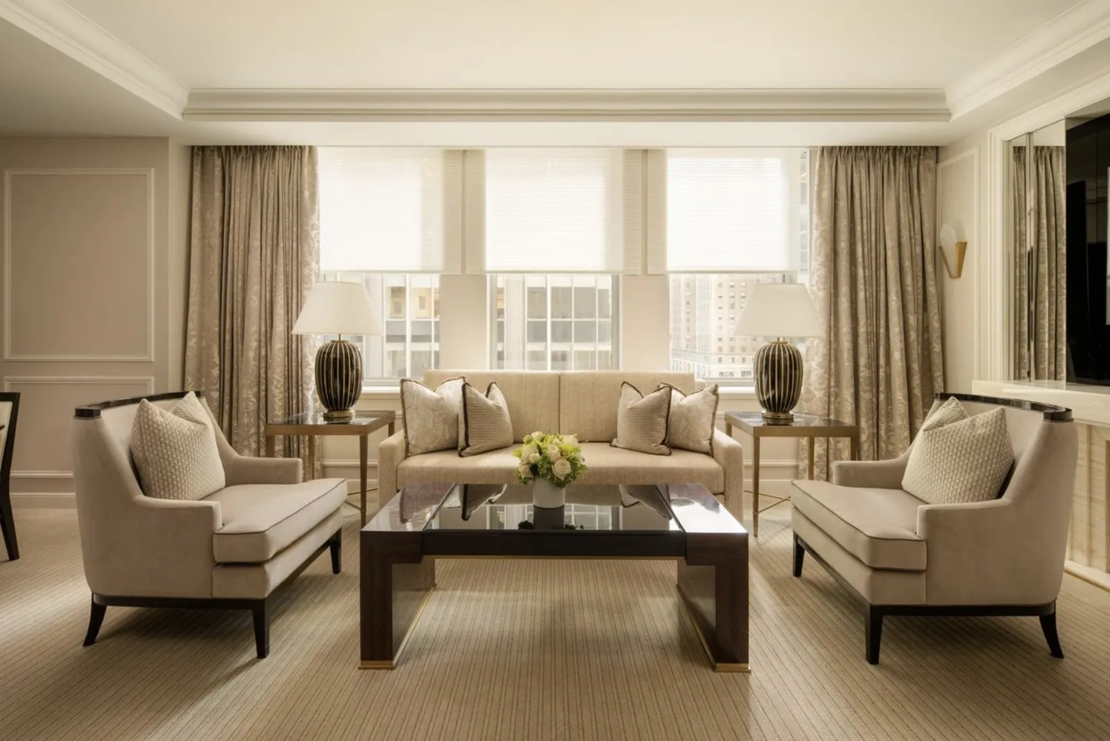 The Two Bedroom Premier Suite living room, armchairs before the windows