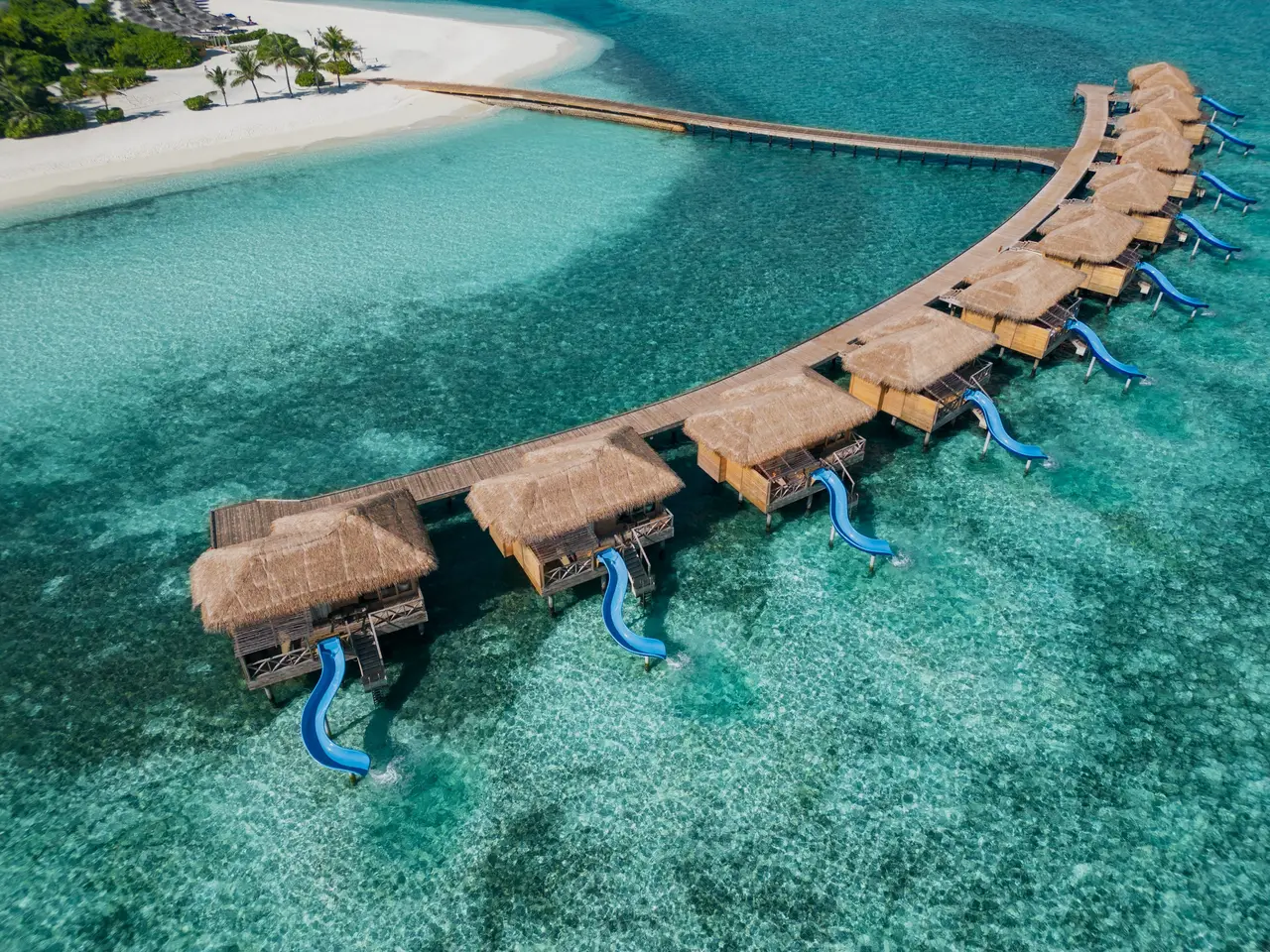 The Aqua Suites with Slide from the air, each with a blue slide down into the lagoon