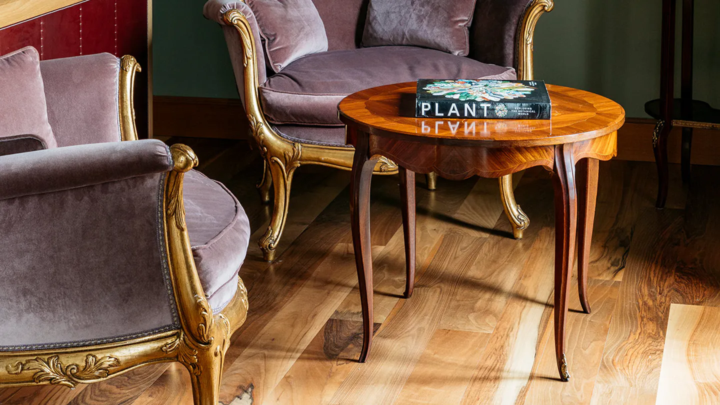 Park-view Junior Suite sitting area with botanical paintings
