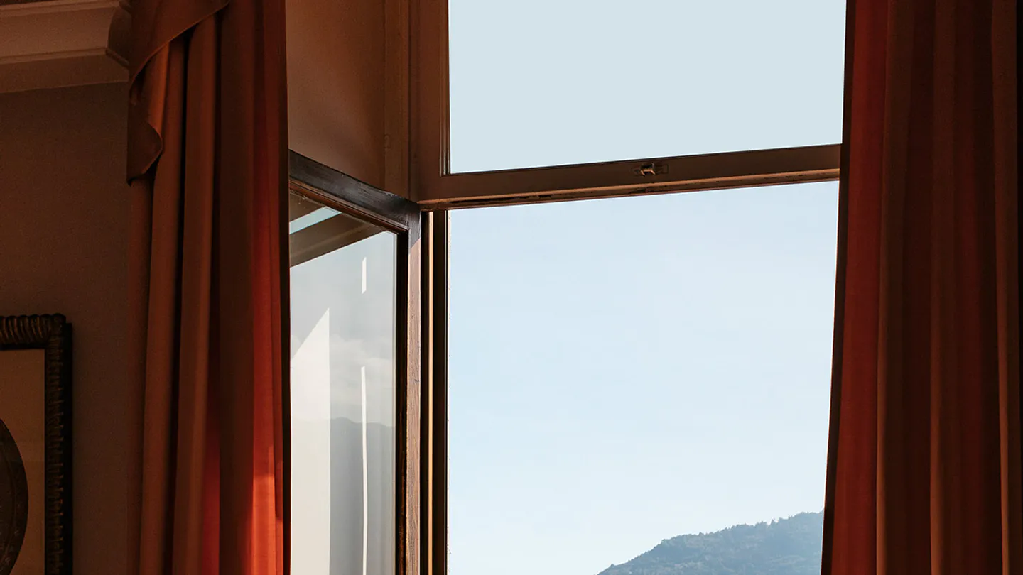 Lake-view Prestige Room balcony with two red chairs