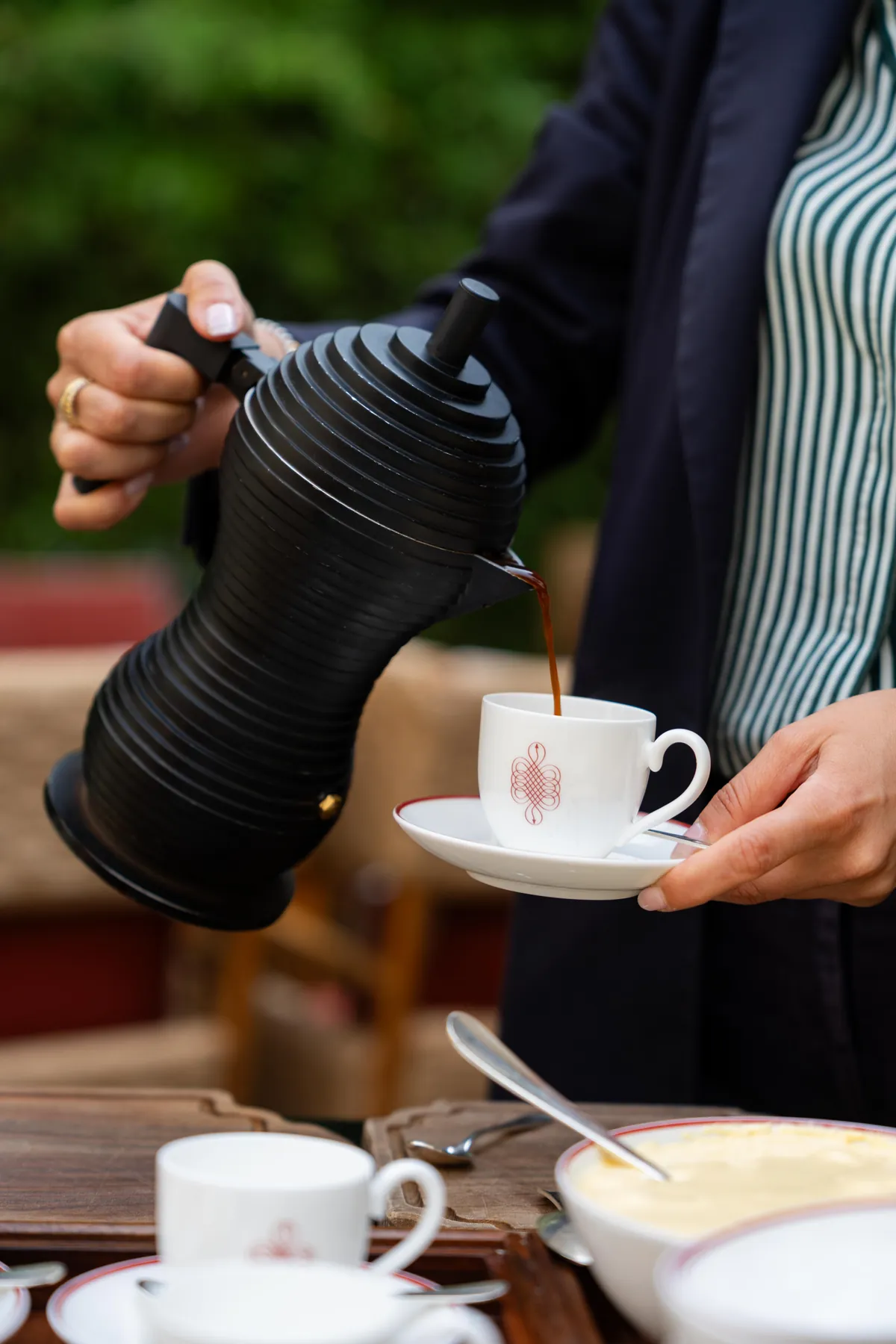 A moka pouring coffee during breakfast at 10_11